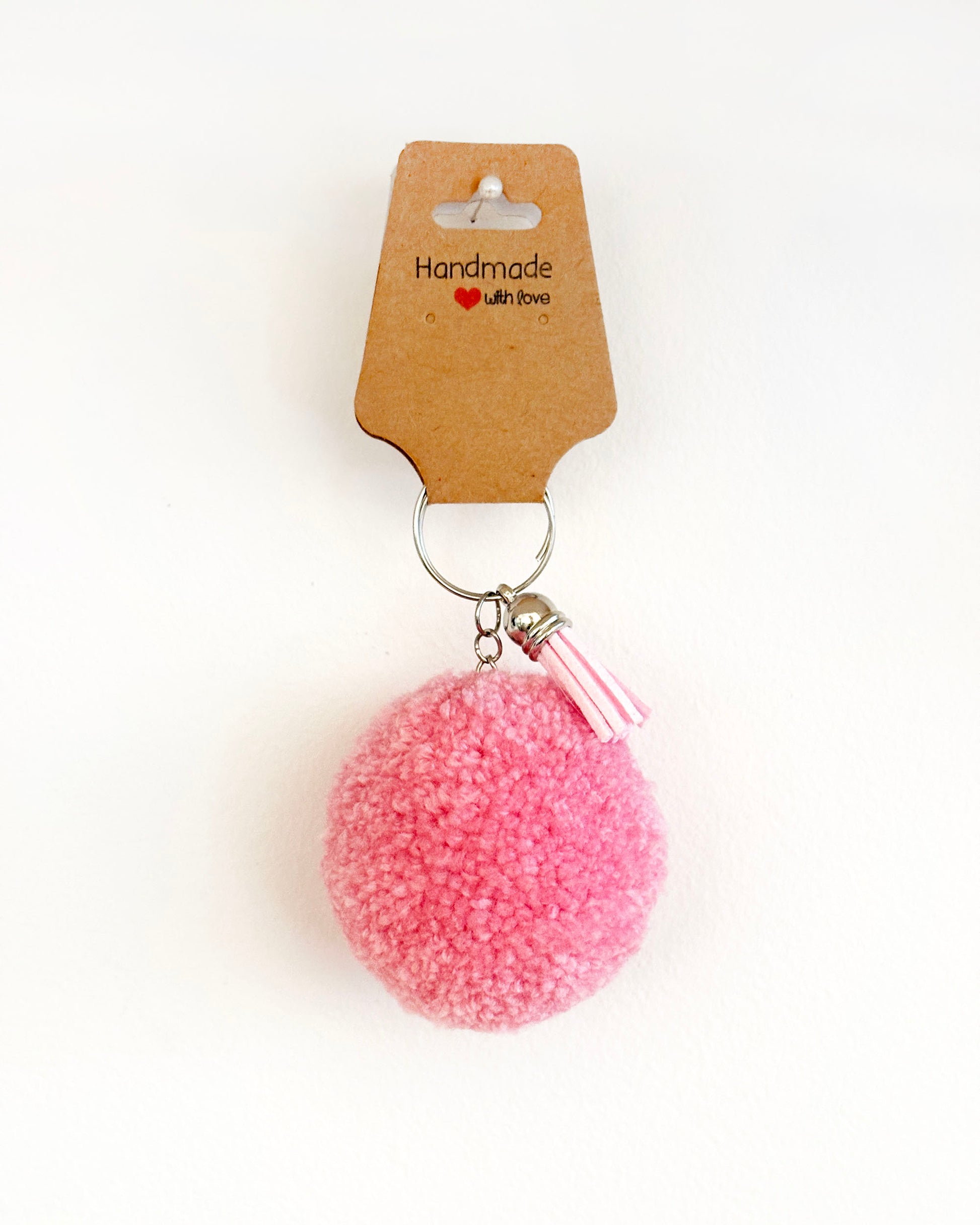 Pom pom obesek roza barve z resico.